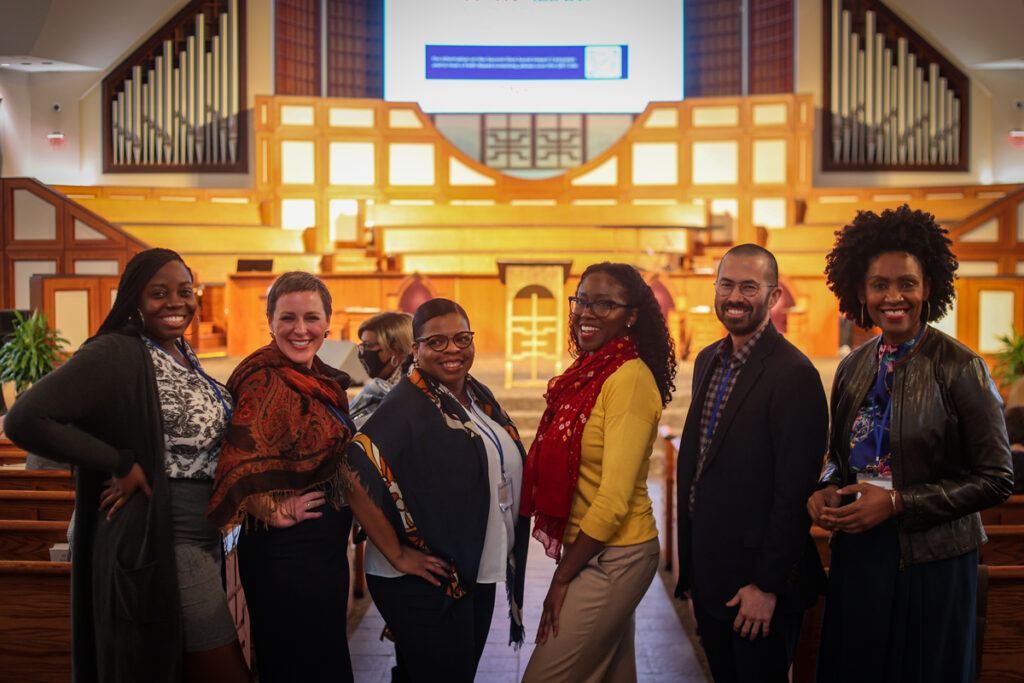 Six EMI conference participants pose together.